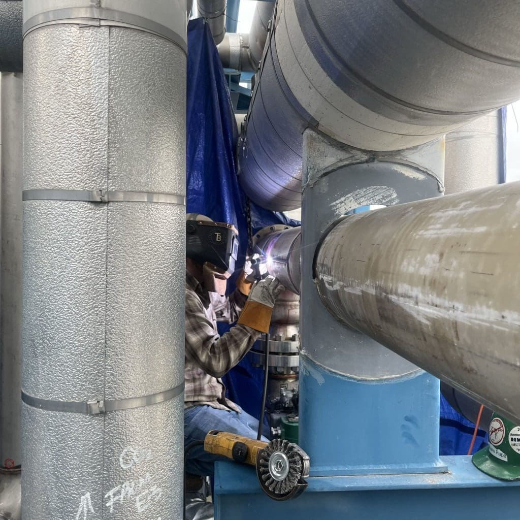 A person welding a pressure vessel.