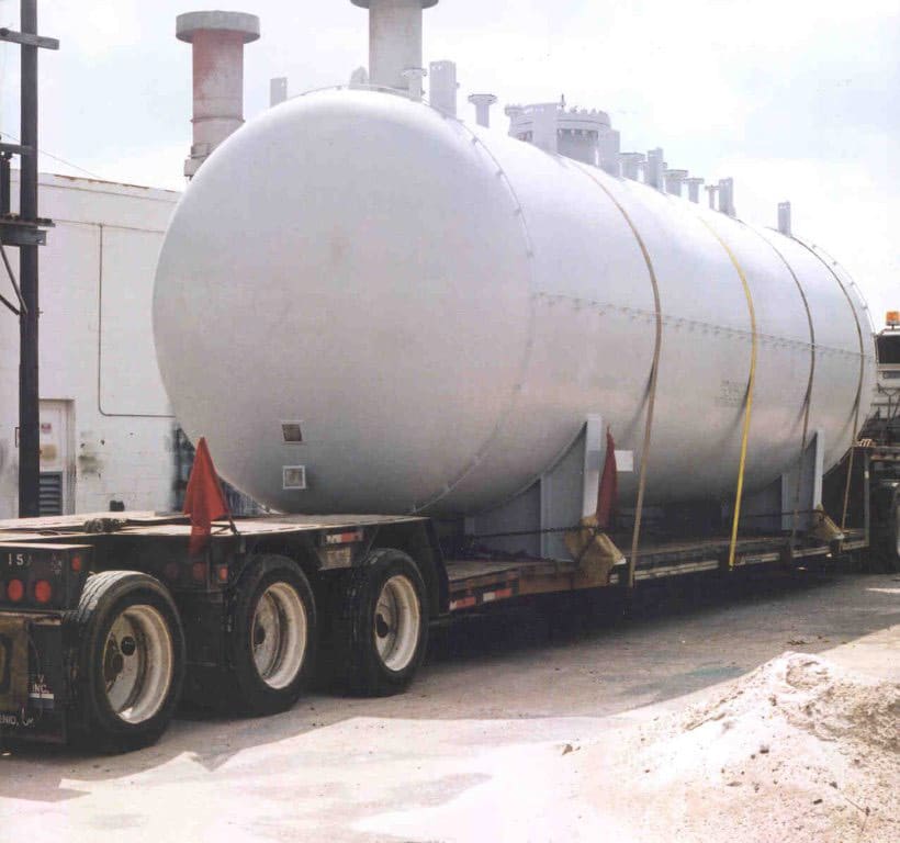 A white pressure vessel on the back of a trailer.