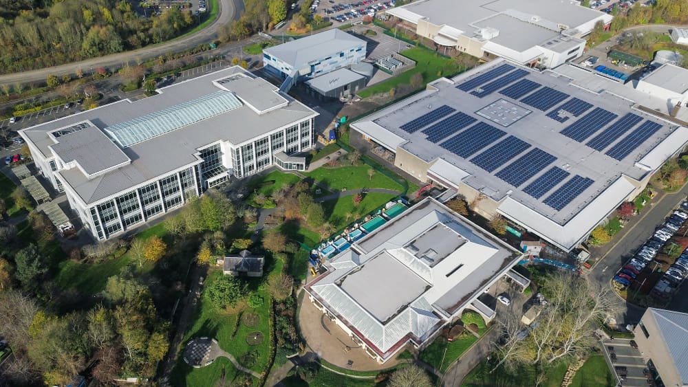 A sky-view of buildings with solar panels.