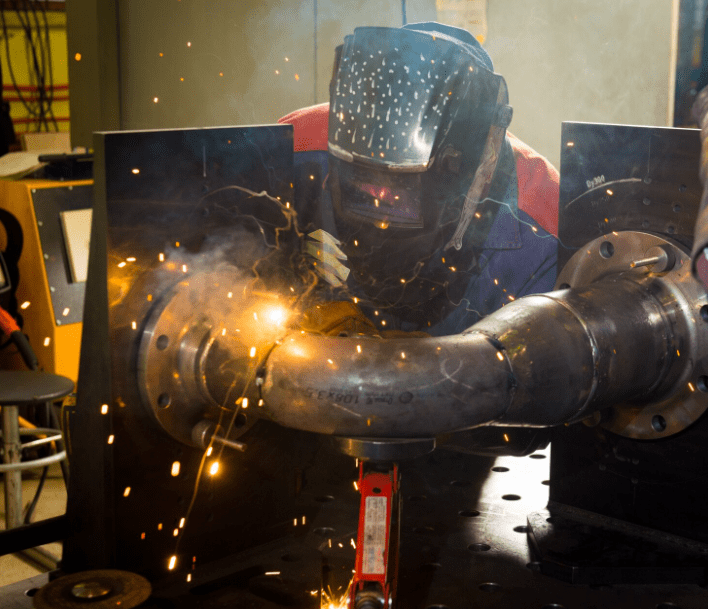 A welder working on a pipe.